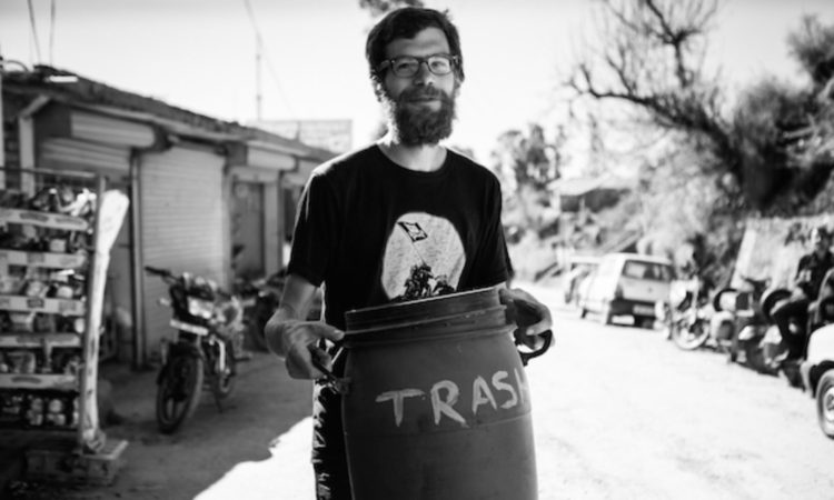 Swash Village volunteer taking up trash